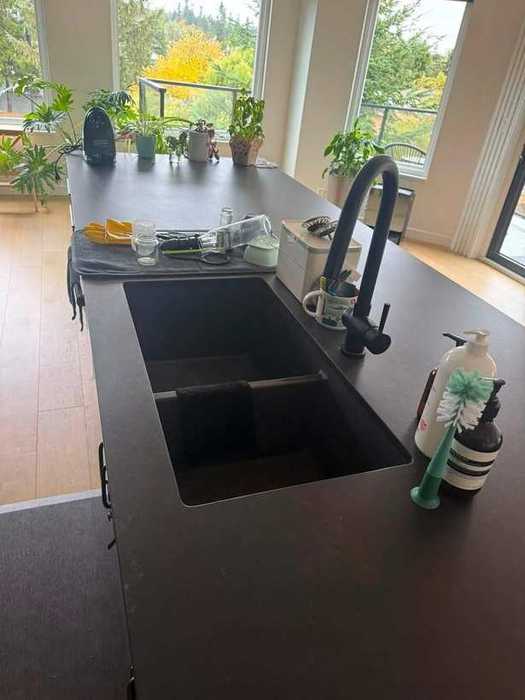 A kitchen island left clear and wiped down at the end of a visit